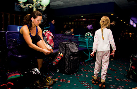 Laura Cohen, 25, laces up her quad skates before a practice for the Snake Pit Derby Dames at Skate Plaza last Thursday.