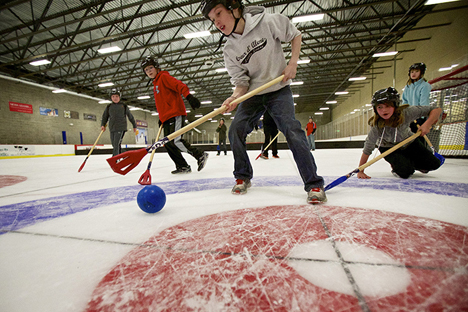 Garret Elder, 10, positions himself between the ball and other players during a game of broom hockey Tuesday at Frontier Ice Arena in Coeur d'Alene.